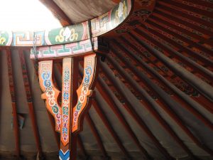 The interior decoration of a traditional Mongolian ger - including the beautiful orange decorative paintwork