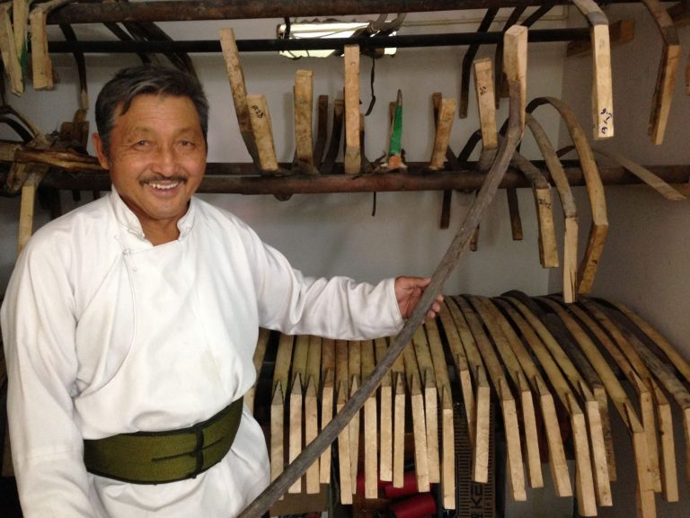 Batmonk - a master bow and arrow maker standing in his workshp, Ulaanbaatar, Mongolia