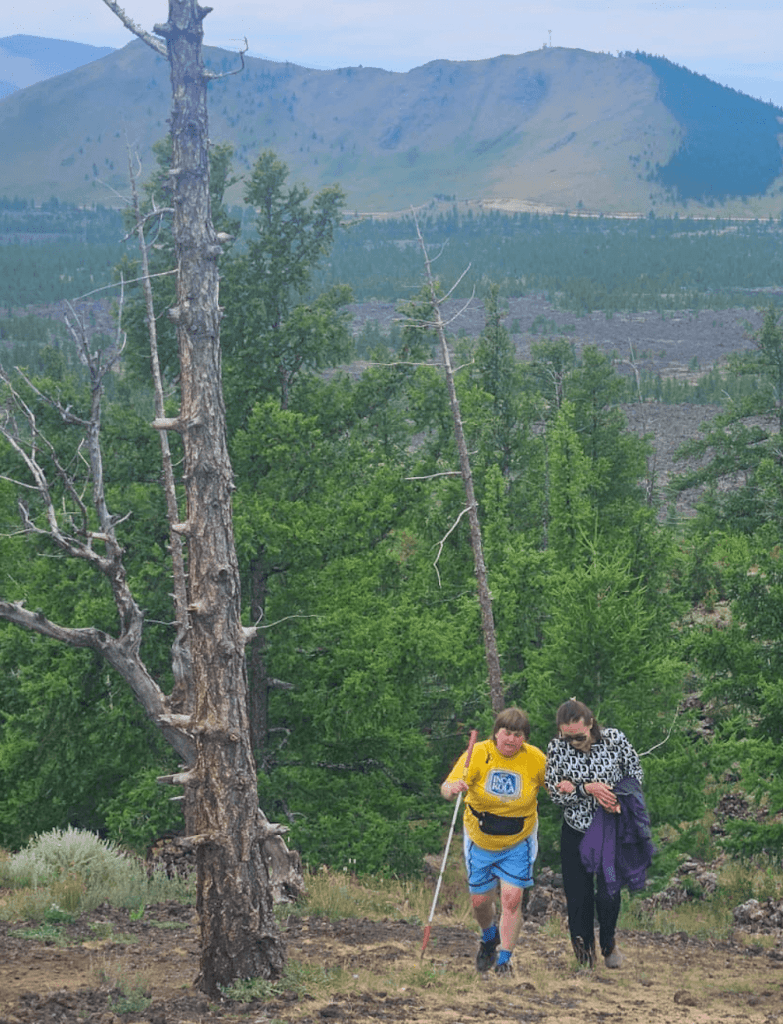 A blind traveller climbing a hill in Mongolia