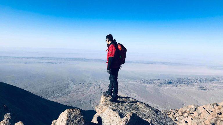 Standing on a rock overlooking Mongolia's landscape - Trekking in Mongolia